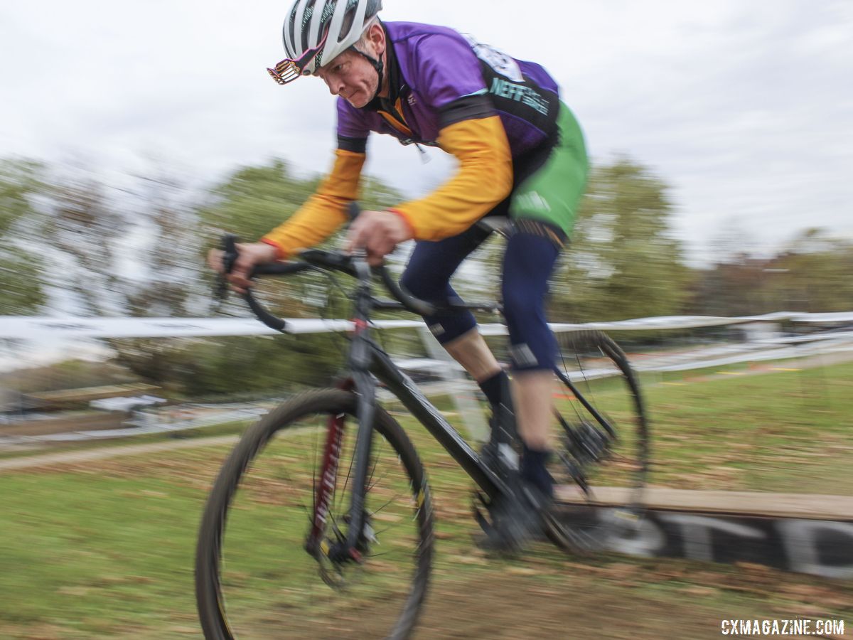 Patrick Flannery, clad in the many colors of Team Neff Cycle Service, hops one of the coffins. 2019 Cross Fire Halloween Race, Wisconsin. © Z. Schuster / Cyclocross Magazine