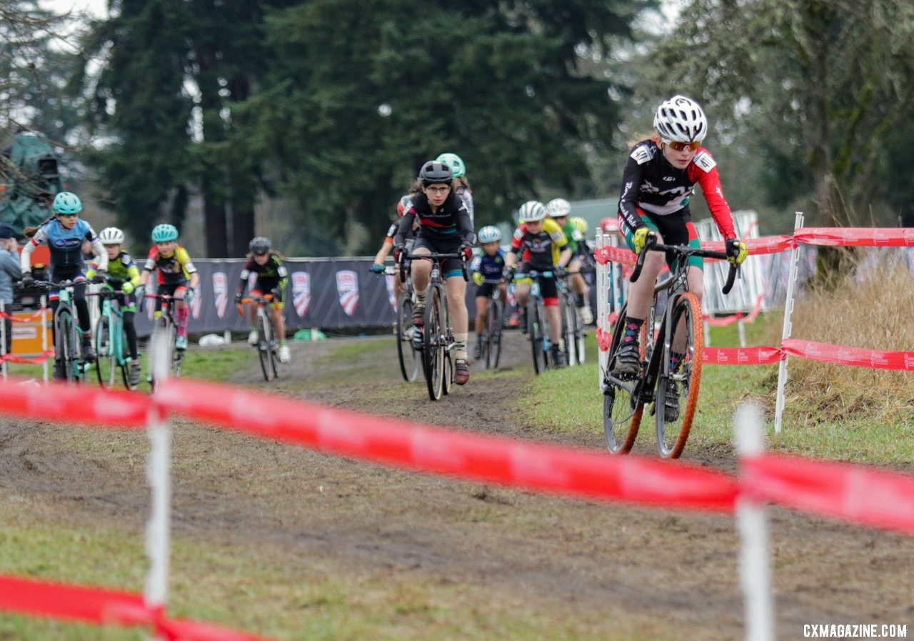 Lily Edwards flies into the lead after making the corner onto the grass. Junior Women 11-12. 2019 Cyclocross National Championships, Lakewood, WA. © D. Mable / Cyclocross Magazine