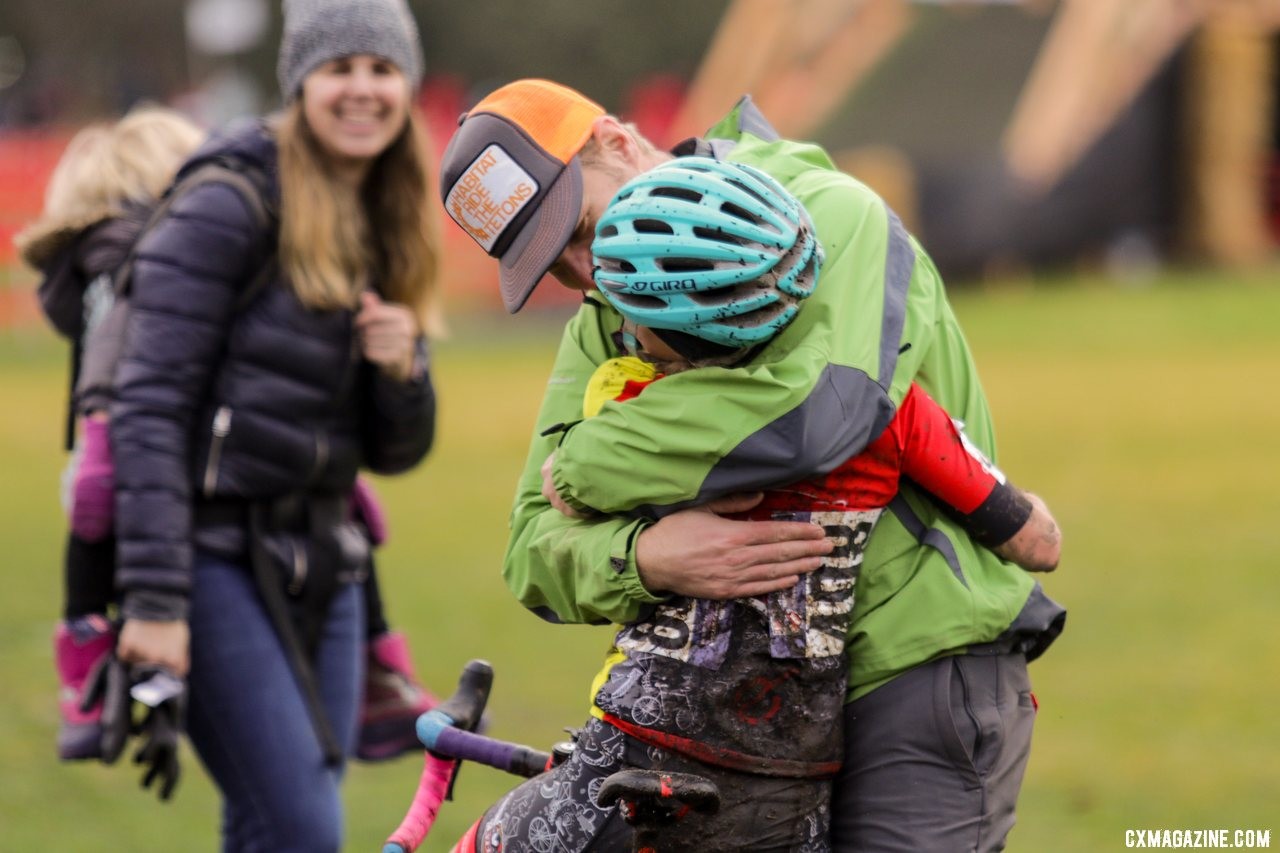 Alexandria Beard gets a warm embrace after finishing third. Junior Women 11-12. 2019 Cyclocross National Championships, Lakewood, WA. © D. Mable / Cyclocross Magazine