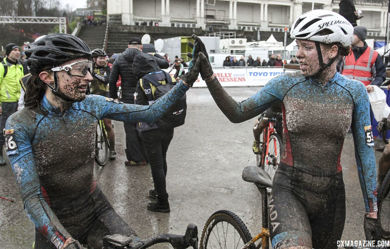 Ruby West and Magdeleine Vallieres Mill share a high five after their race. 2018 World Cup Namur. © B. Hazen / Cyclocross Magazine