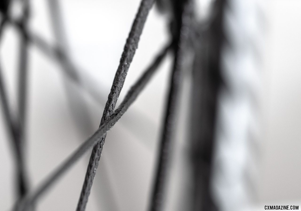 Berd's polymer spokes claim 12 times the strength to weight ratio of steel spokes. Atomik's Ultimate Berd carbon tubeless wheels with Berd polyethylene spokes. © Cyclocross Magazine