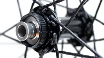 Berd spokes are still laced and crossed in a traditional fashion. Industry Nine Centerlock hubs feature compatibility with a variety of axle systems. Atomik's Ultimate Berd carbon tubeless wheels with Berd polyethylene spokes. © Cyclocross Magazine