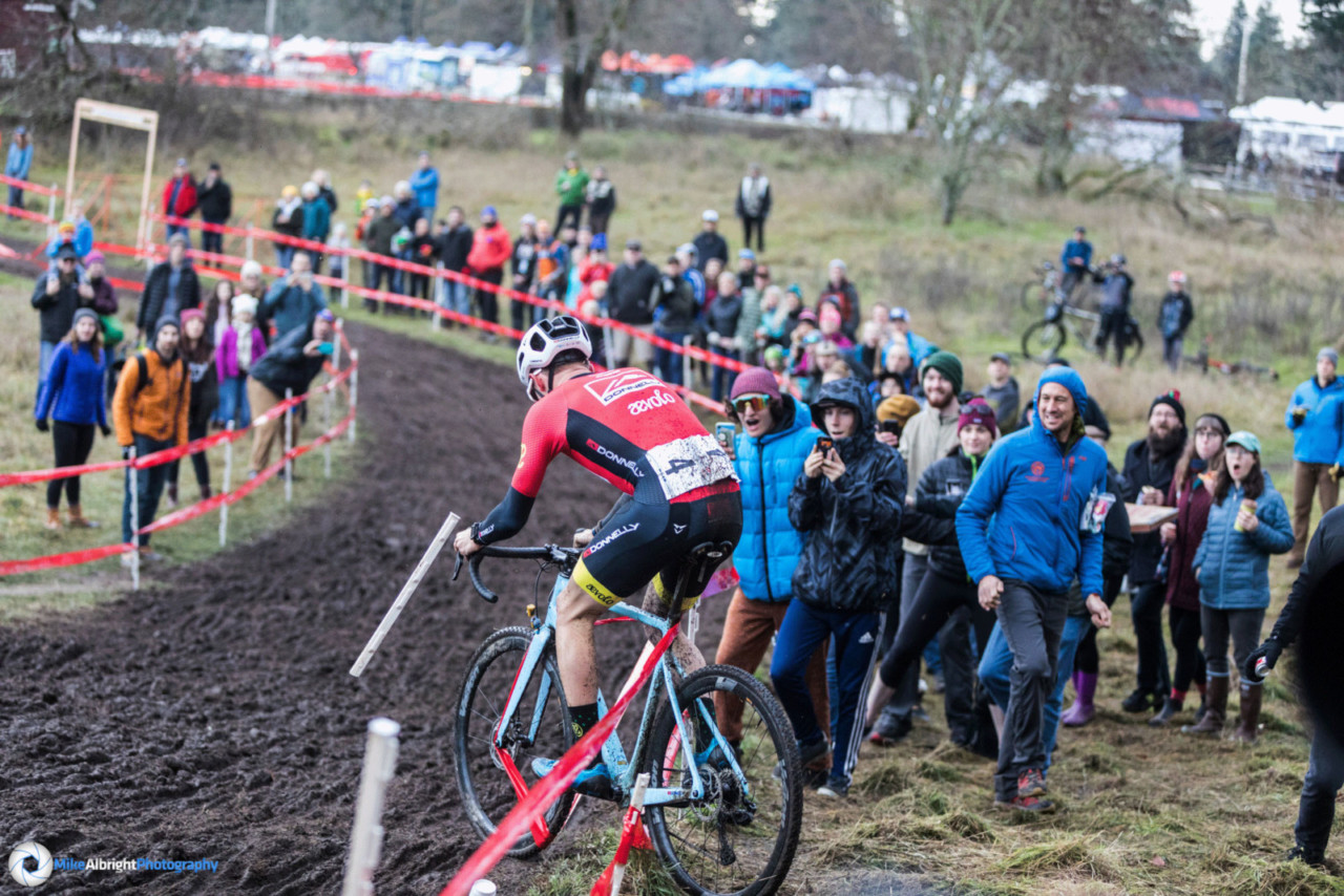 Gage Hecht and Kerry Werner get caught in the course tape on lap two at the 2019 Cyclocross Nationals. Photographer Mike Albright captured the sequence. © Mike Albright