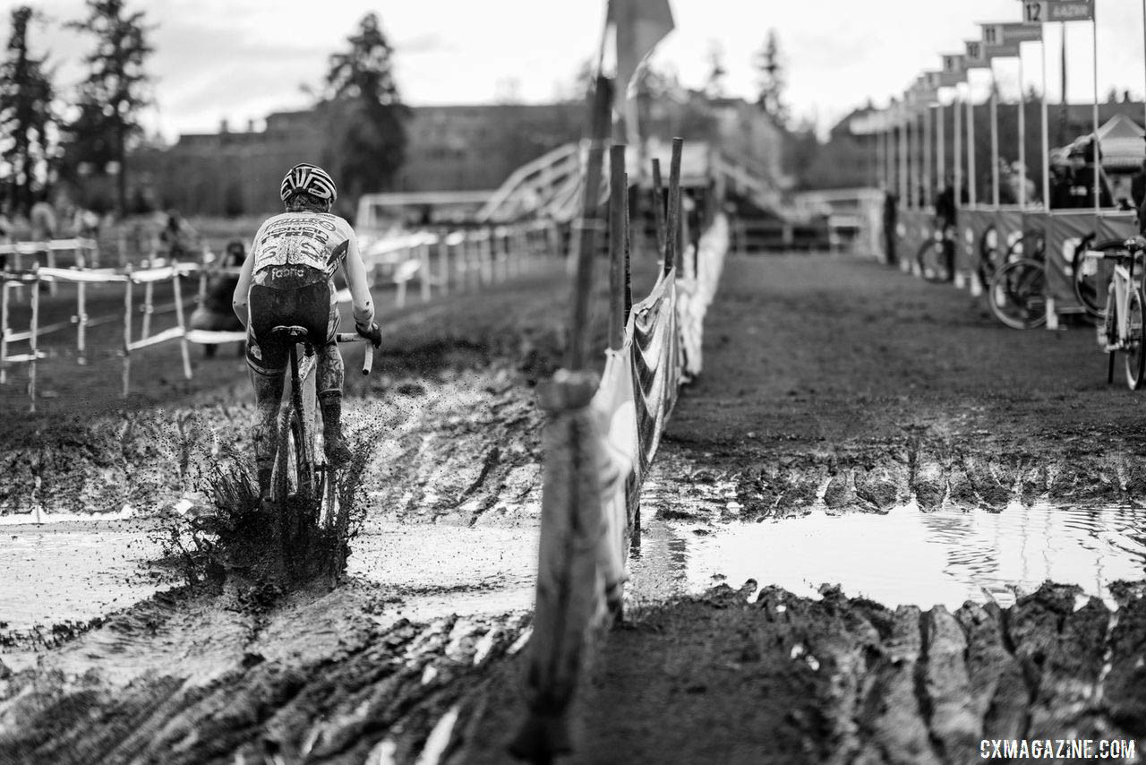 Power washers caused a few puddles near the pit - Molly Cameron shown blasting through on Sunday. 2019 Lakewood U.S. Cyclocross Nationals. © Drew Coleman