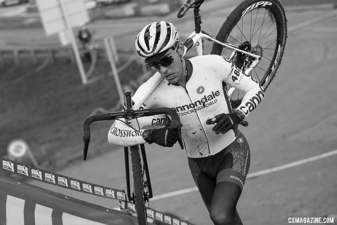 Curtis White grimaces a bit as he heads up the stairs. 2020 World Cup Nommay, France. © B. Hazen / Cyclocross Magazine