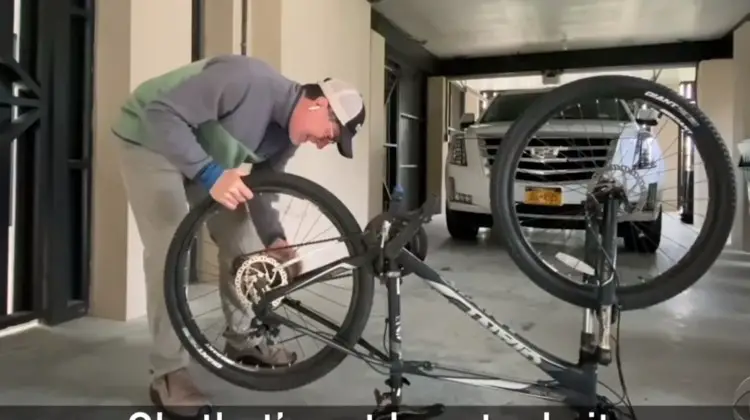 Stephen Colbert fixes a flat tire during the coronavirus shelter-in-place order.