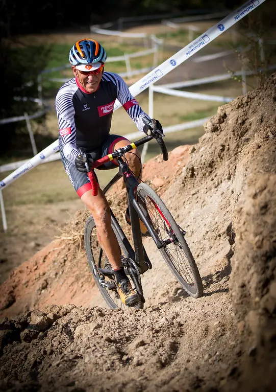 Lee Waldman riding up a dirt slope.