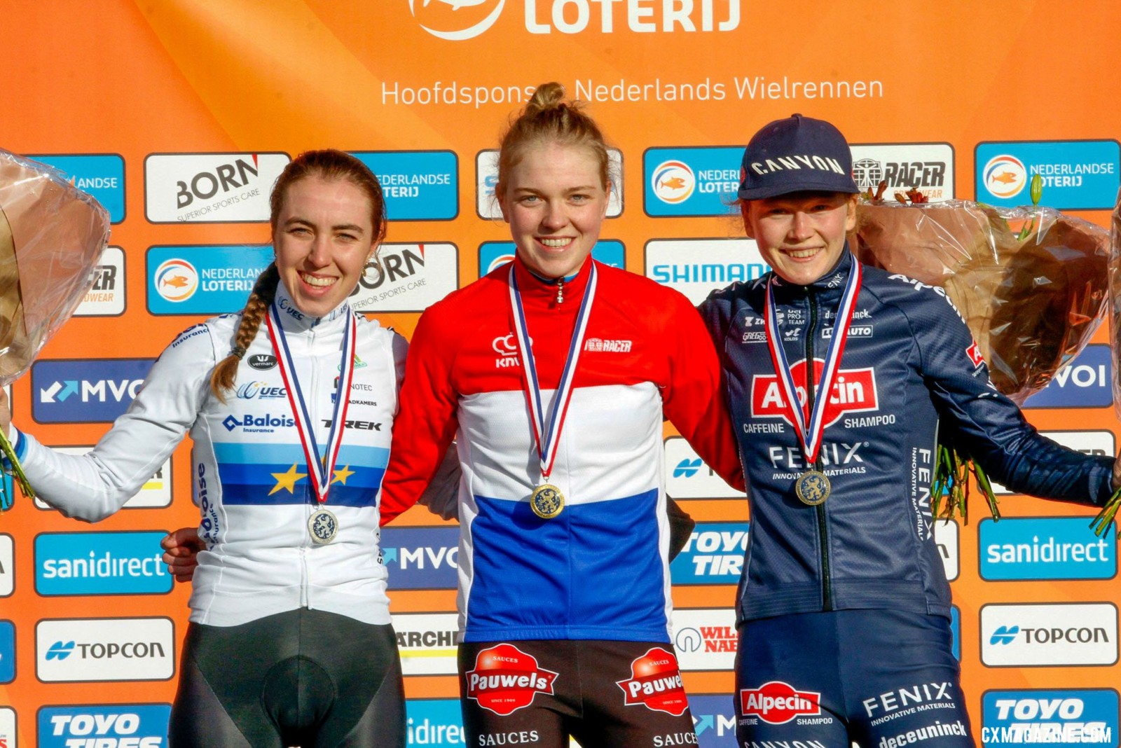 Fem van Empel, Shirin van Anrooij, and Puck Pieterse on the podium. 2022 Dutch Cyclocross National Championships, Elite Women. Rucphen. © B. Hazen / Cyclocross Magazine