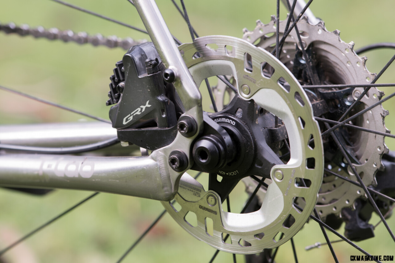 The bolt-on one-piece axle and caliper mount of the T-Lab X3 is default for a 140mm rotor. Access to the front caliper mount is blocked, so a 8mm hex-head cap screw ireplaces the ussal allen head bolt. © C.Lee/ Cyclocross Magazine