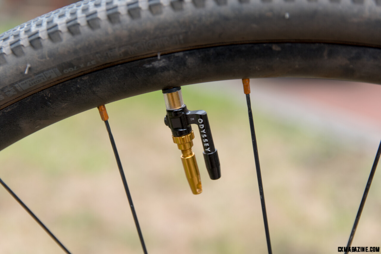 The gold cap has a core remover. Note our DIY valve spacer between the rim an the black tire valve.
