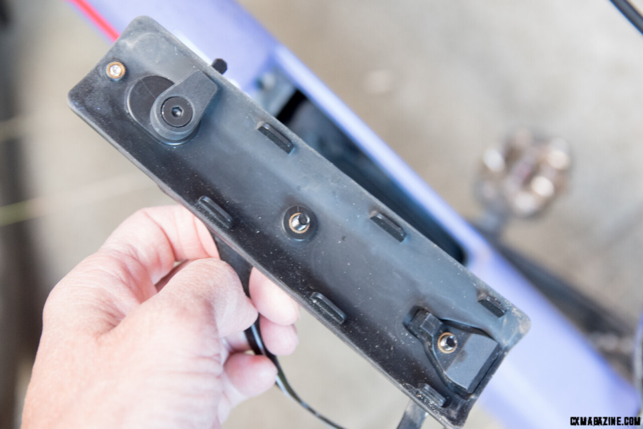 back of the trapdoor that covers the downtube storage. Note the bottle cage bolts protruding and the locking points